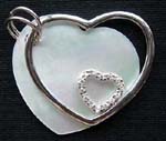 Silver plated custome jewelry at wholesale price. Heart shaped brooch holding rhinestone heart 