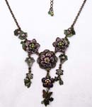 Design necklace fashion distribution supplier. Floral design necklace witin purple and green enamel dangling from classic chain 