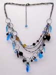 Online womens jewelry manufacturing supplier. Multi chained fashion necklace with blue and yellow crystals, hoop links, and black beads