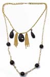 Vintage wholesale womens accessory supplier. Fashion necklace with gold plated chains holding black crystals, gold tassels, and solid black bead balls 